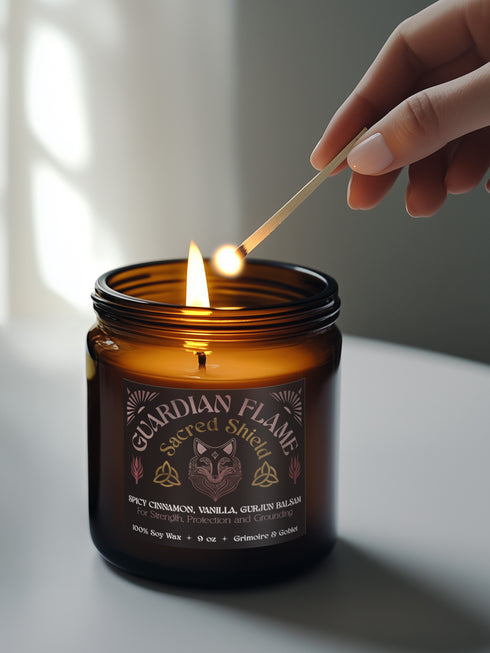 Amber glass jar with Guardian Flame label featuring a metallic wolf and flame motifs in pink and gold. Spicy cinnamon, vanilla, and gurjun balsam candle. 9 oz soy candle by Grimoire & Goblet.